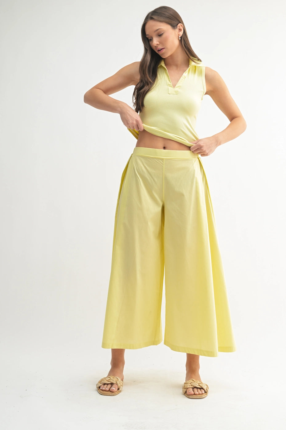 Woman wearing a yellow outfit on a white background