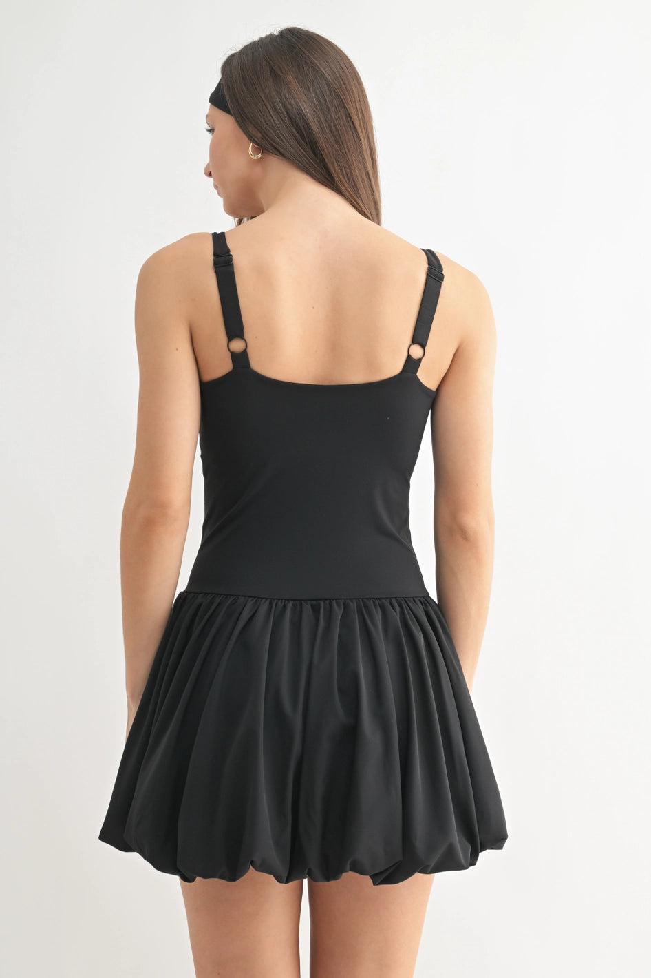 Black dress with thin straps with a bubble skirt on a white background