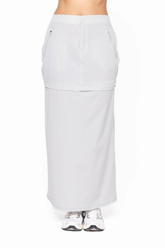 Light gray skirt worn by a person on a white background
