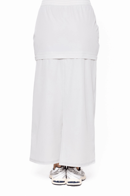 Light grey skirt and pants set on a white background